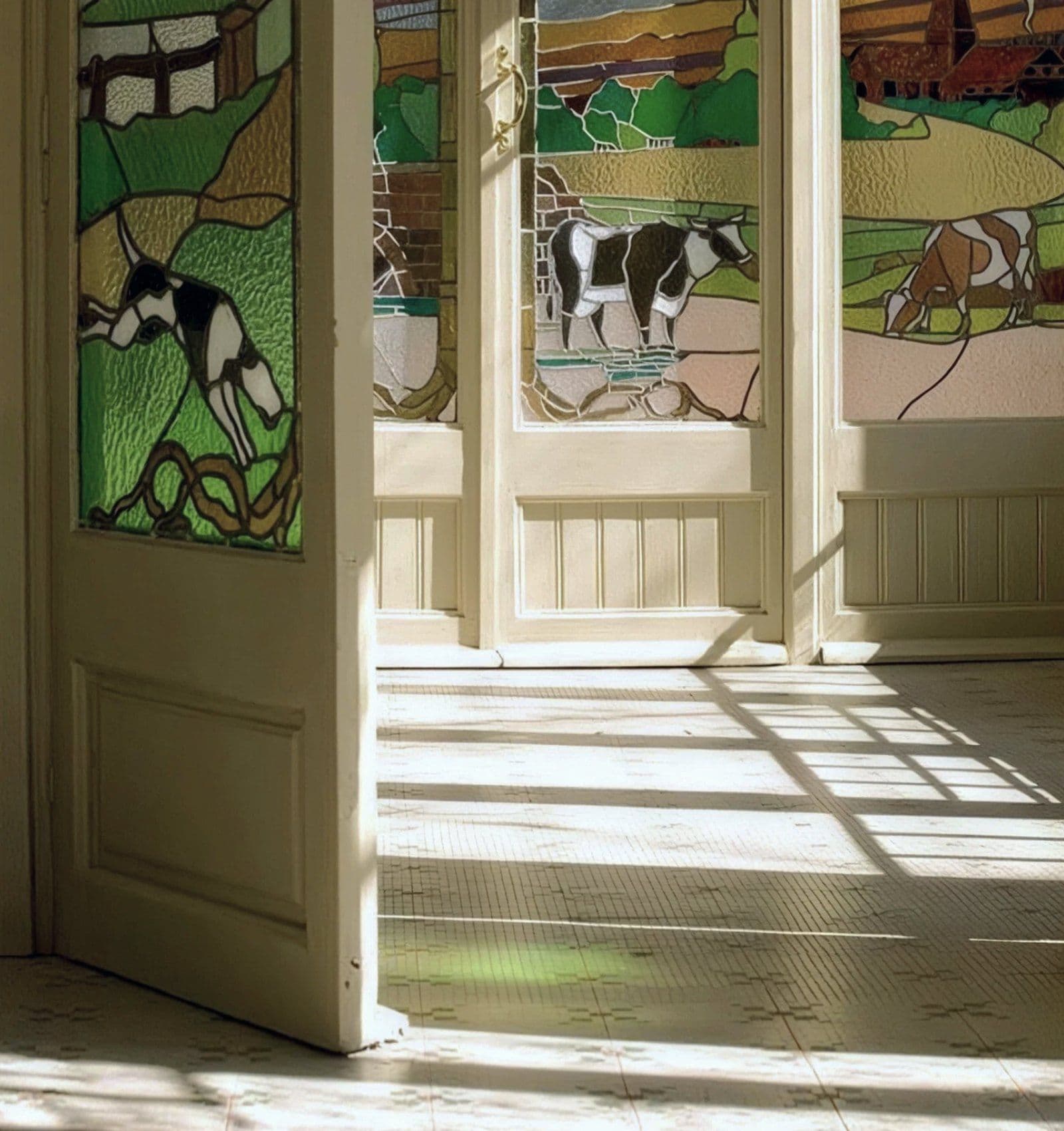 Stained-glass doors open onto the café, in afternoon light