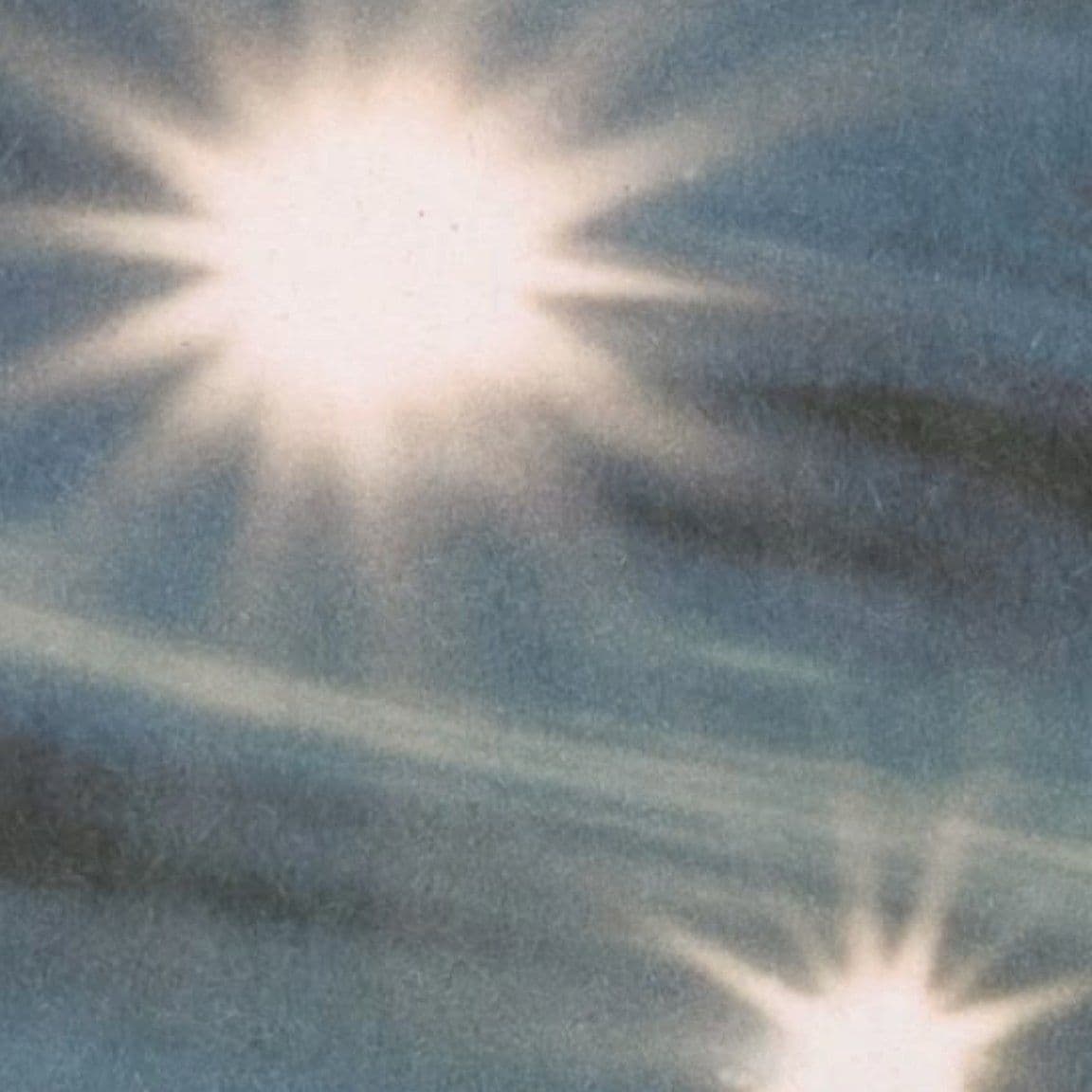 Flashes of sunlight over a blue sky