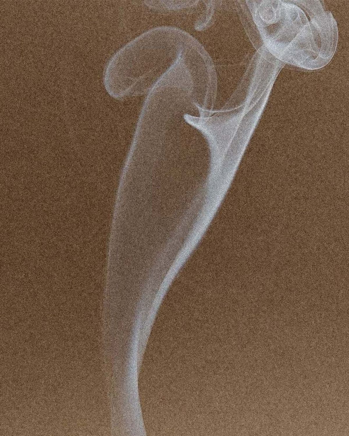 Wisp of smoke against an ochre background