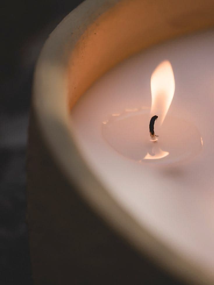 The flame of a lit candle