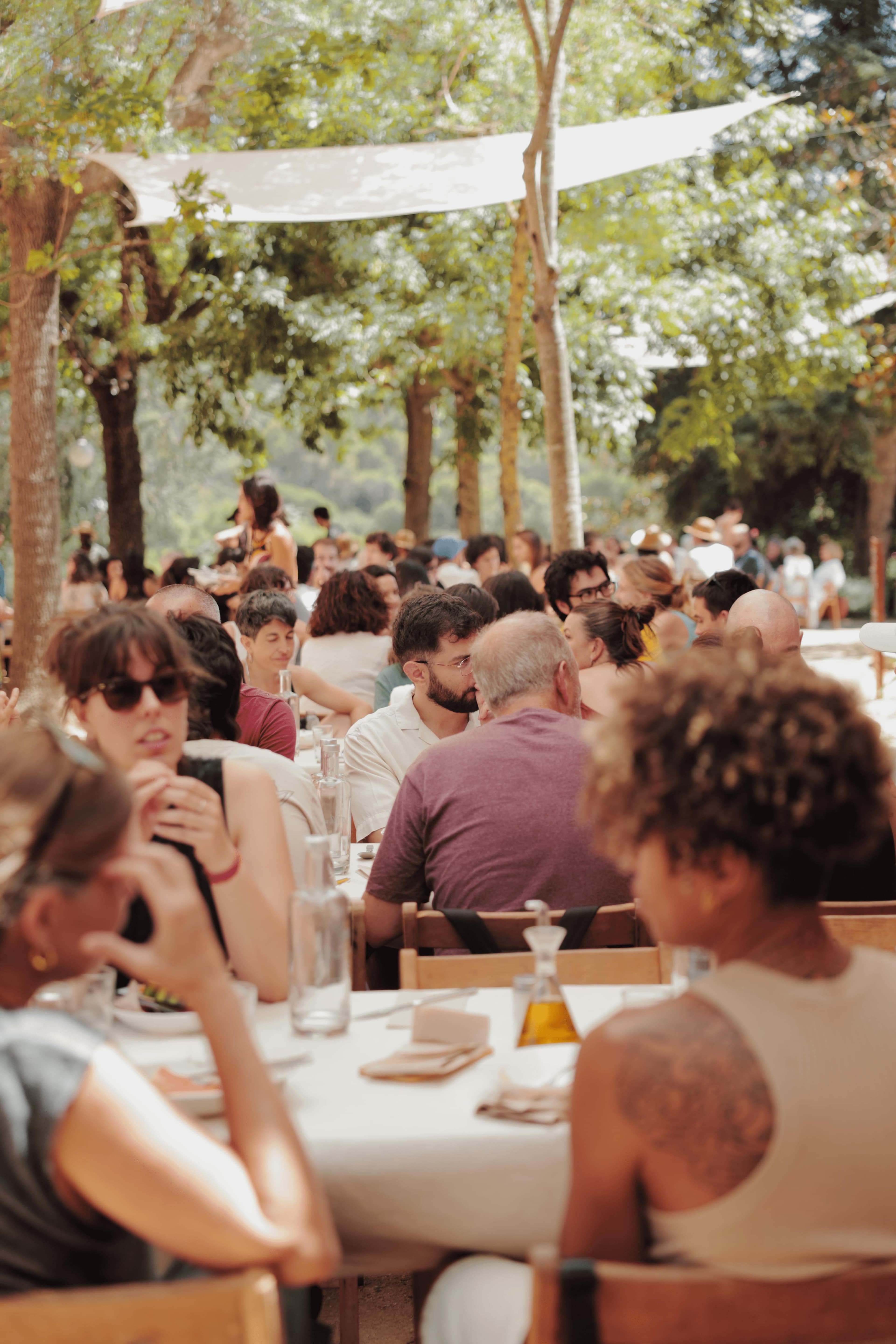 Group of people eating outdoors, celebrating the end of an activity